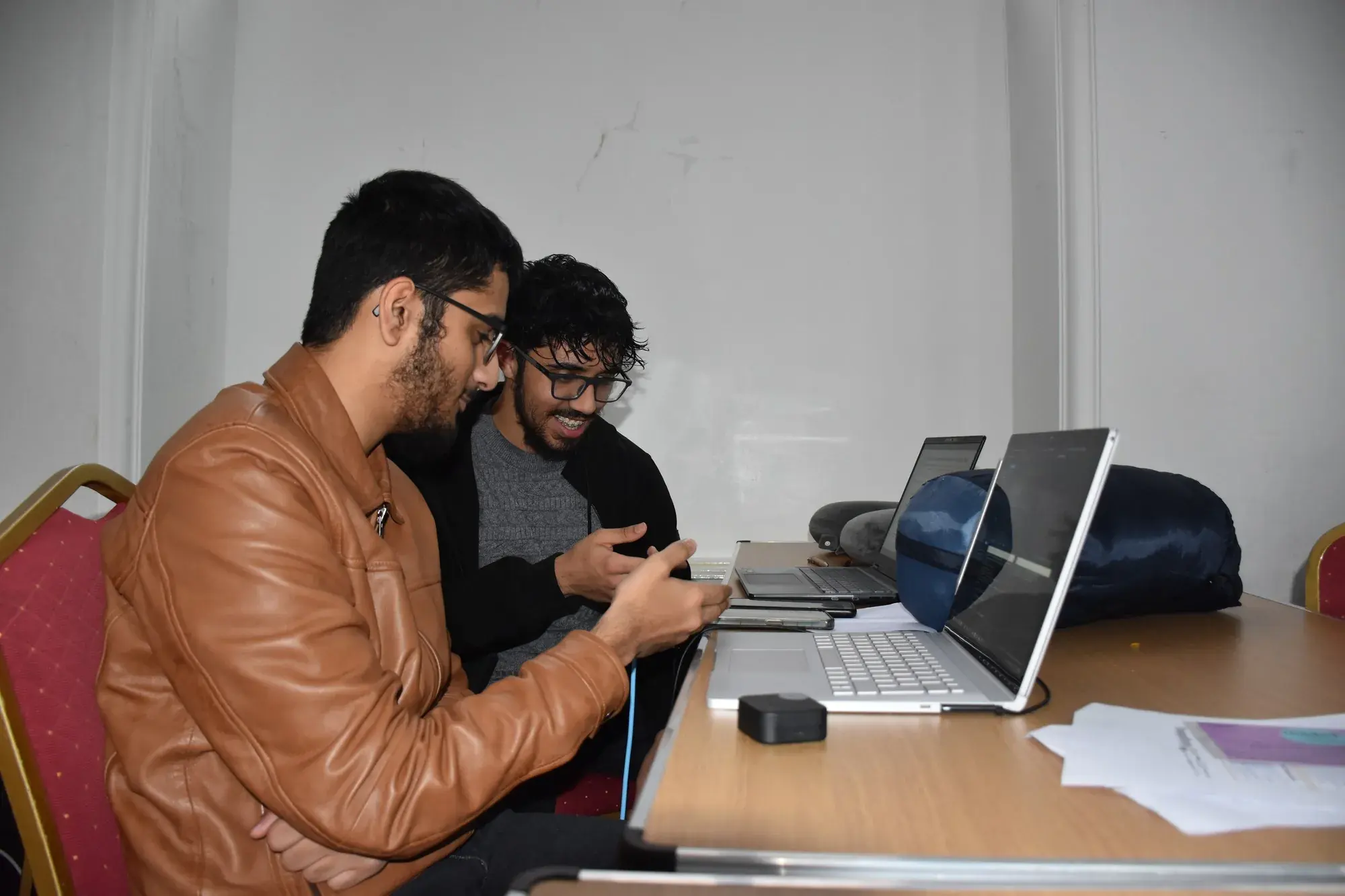 Two participants reviewing something on a phone together