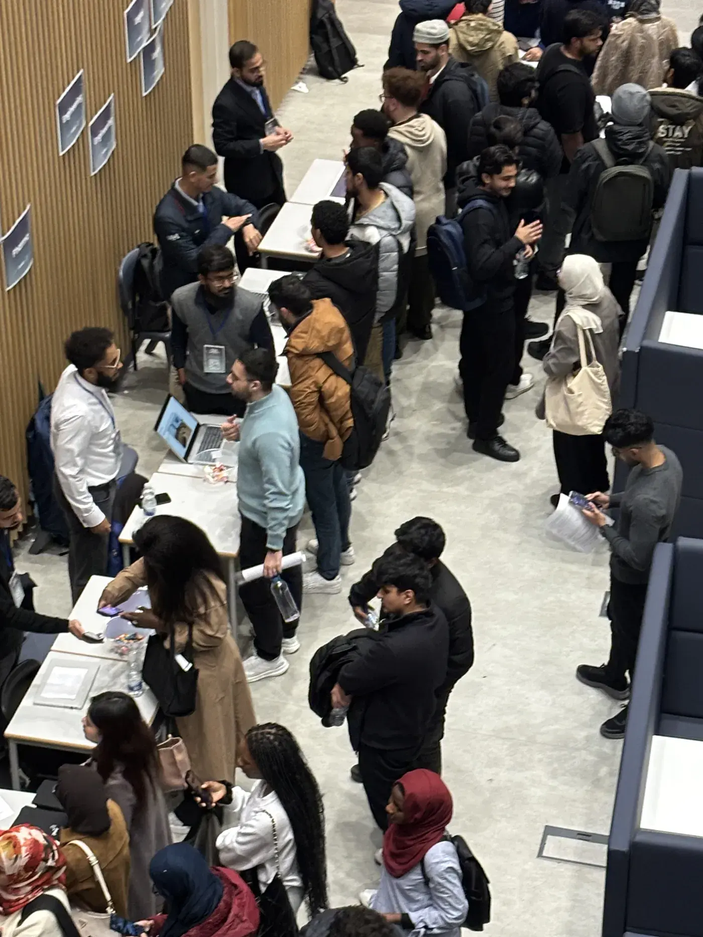 An overhead view of students queuing to meet employers